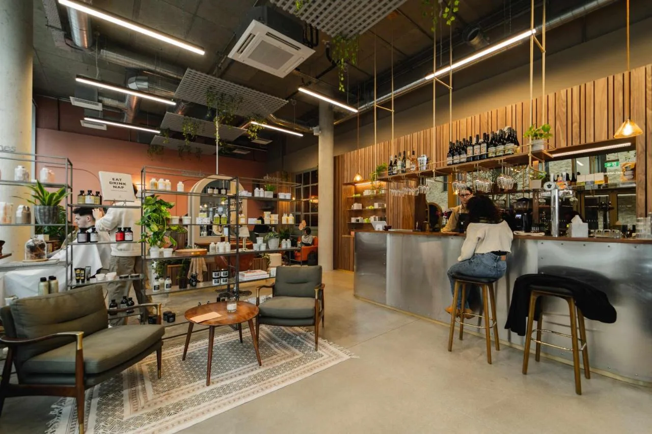 a restaurant with a bar with chairs and a counter at Turing Locke Cambridge in Cambridge